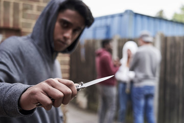  Teenage Boy In Urban Gang Pointing Knife Towards Camera