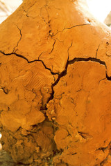 Large orange earthen vessel covered with cracks. texture background