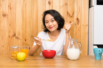 Asian young woman having breakfast