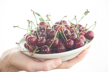 Ripe, red cherry on a wooden table