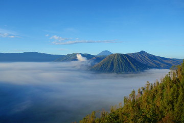 Fototapeta na wymiar Mount Bromo volcano during sunrise, the magnificent view of Mt. Bromo located in Bromo Tengger Semeru National Park, East Java, Indonesia