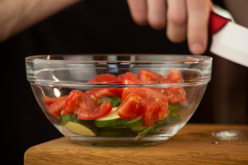 Beautiful, juicy tomato sliced on a wooden table