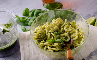 Homemade pasta with fresh basil pesto and tomatoes