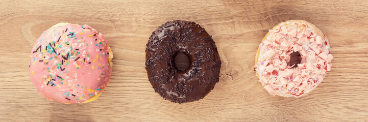 tree sweets donuts on the table panorama