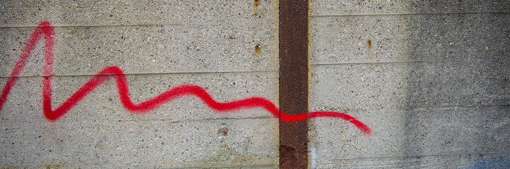 concrete wall with a trace of red paint.