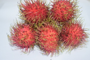 Fresh red rambutans fruit on white colour background 