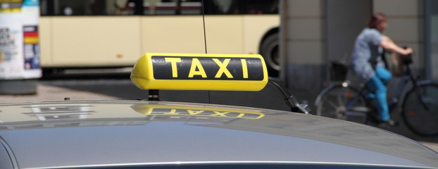 a TAXI sign on a car roof