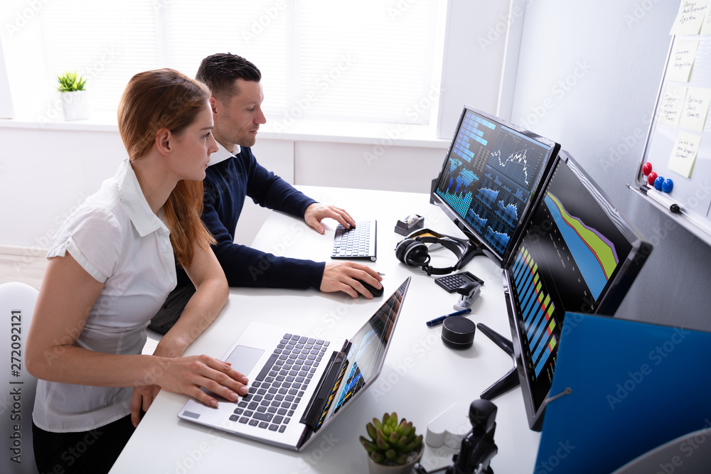 Poster Two Businesspeople Examining Graph On Computer