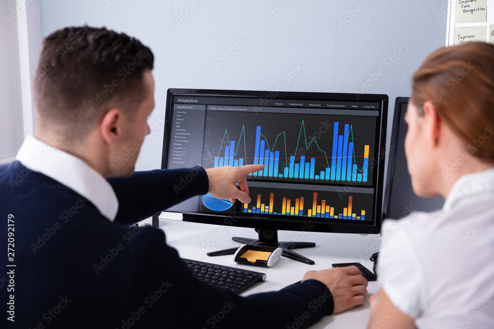 Poster Two Businesspeople Examining Graph On Computer