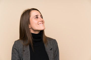 Obraz premium Young woman over isolated wall laughing and looking up