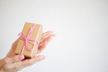 girl holding a box with a gift. minimalism