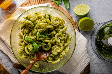 Homemade pasta with fresh basil pesto and tomatoes