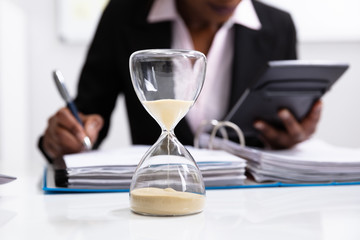 Close-up Of A Hourglass On Desk