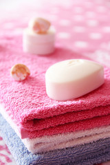 white toilet soap and decor against the background of pink terry towels