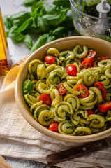 Homemade pasta with fresh basil pesto and tomatoes