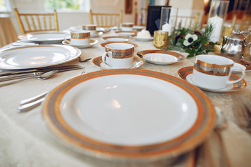Beautiful wedding decor. Golden dishes in a wedding table