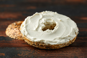 Bagels sandwich with cream cheese on wooden table