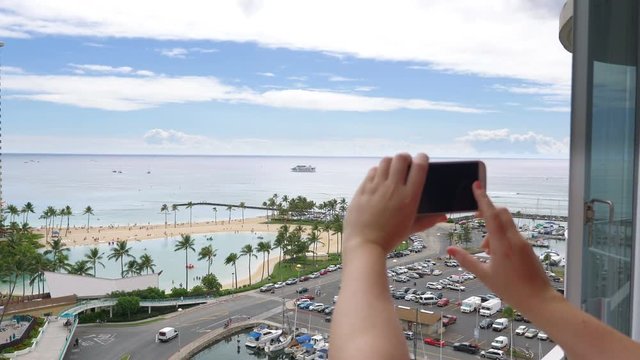 Woman taking picture of Waikiki beach in Hawaii in 4K slow motion 60fps