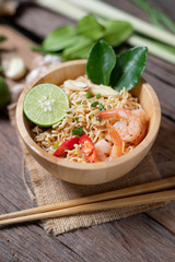 Close-up shot Instant noodles with lemon shrimp chilli hot and spicy on old wooden table select focus shallow depth of field