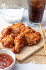 Hot and spicy Korean barbeque fried chicken on wood cutting board