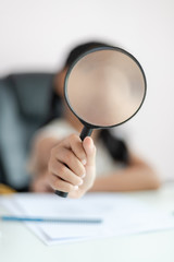 Fototapeta premium Little Asian girl using magnifier doing homework and smile with happiness for education concept select focus shallow depth of field
