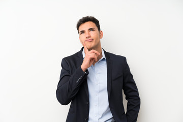 Handsome man over isolated white wall thinking an idea