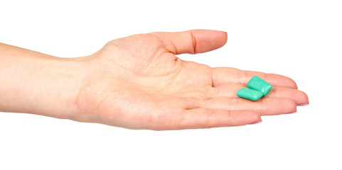 Hand with bright chewing gum, dental bubblegum.