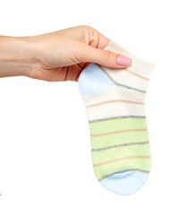Hand with striped cotton sock, child footwear.