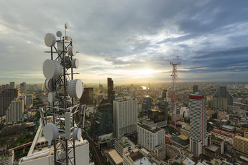 Telecommunication tower with 5G cellular network antenna on city background