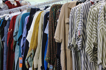 Clothes on hangers at the closet or clothing store 