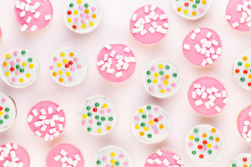 Colorful cupcakes on a white background.