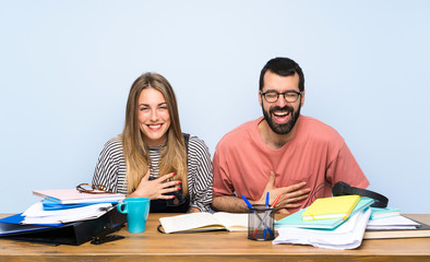 Students with many books smiling a lot