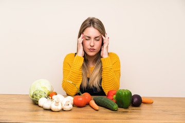 Fototapeta premium Woman with lots of vegetables unhappy and frustrated with something. Negative facial expression