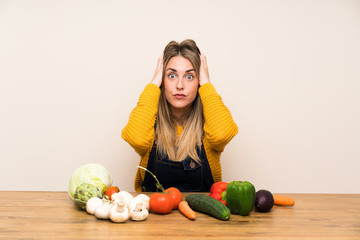 Fototapeta premium Woman with lots of vegetables with surprise facial expression