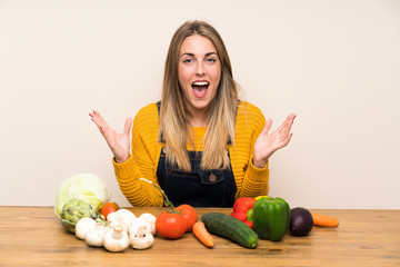 Fototapeta premium Woman with lots of vegetables with surprise facial expression