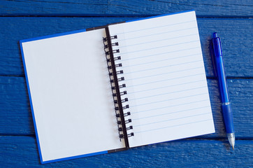 Open notepad with a pen