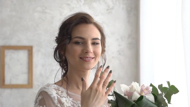 Bride Smelling Flowers In Wedding Bouquet