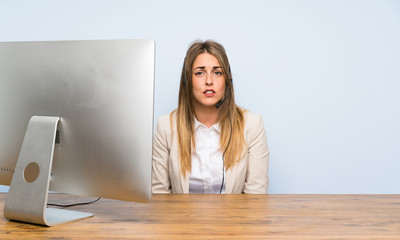 Young telemarketer woman having doubts and with confuse face expression