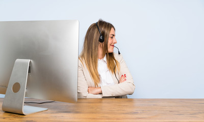 Young telemarketer woman standing and looking to the side