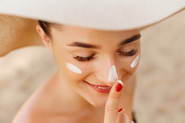 Suntan lotion woman applying sunscreen solar cream. Beautiful happy cute woman  applying suntan...