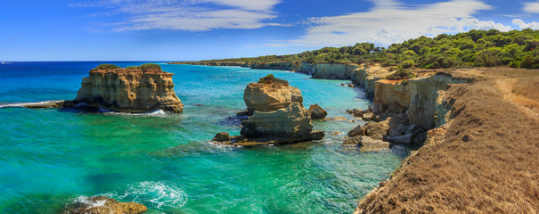 The most beautiful coast of Apulia: Torre Sant' Andrea, Otranto , ITALY (Lecce).Typical coastline of Salento: view of Punticeddha beach. Seascape with cliffs, rocky arch and sea stacks (faraglioni).