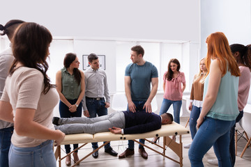 Man Giving Teaching Massage To Group Of People