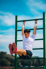 Fototapeta premium Strong young adult man doing abdominal exercise. Crossfit training