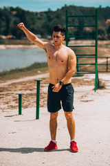 Young man training on beach outside