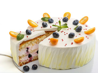 Cake with blueberries and mint. One small piece cut from it. On a white background, not isolate.