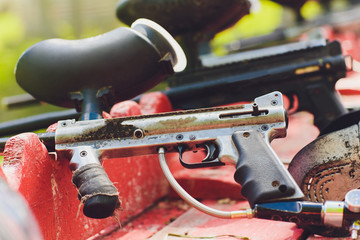 Paintball guns on a wooden table. play paintball.