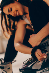 Girl preparing for roller blading, putting on rollerblades