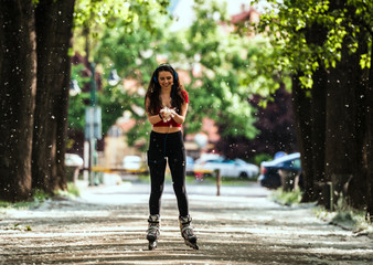 Skating woman on rollerblades in park