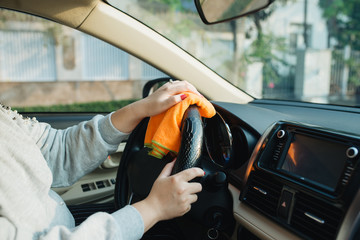 Hand with microfiber cloth cleaning seat, auto detailing and valeting concept, washing car care...