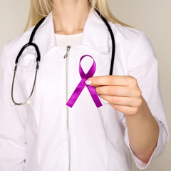 Female doctor in white uniform with purple awareness of ribbon in hand for ADD,ADHD,Alzheimer...